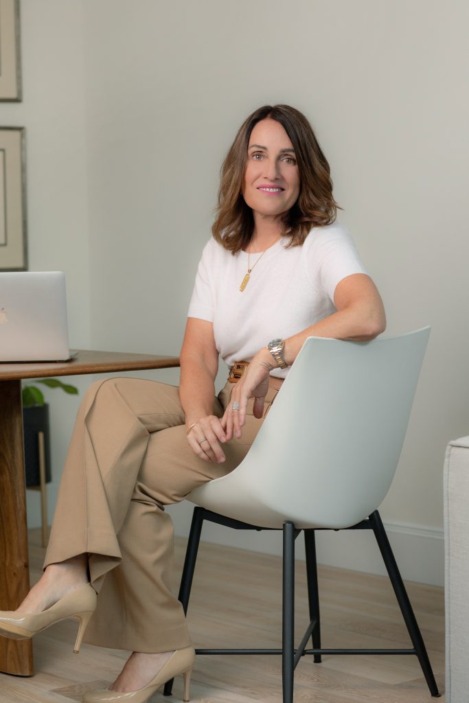 Portrait of Ellen McGinnis seated in her studio
